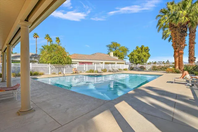 a view of a swimming pool with a lounge chairs