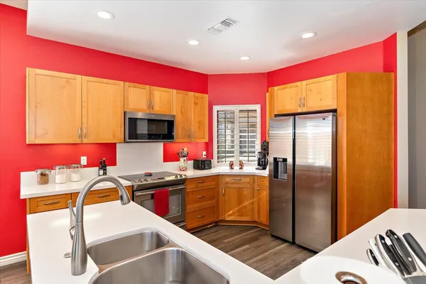 a kitchen with stainless steel appliances granite countertop a refrigerator and a stove