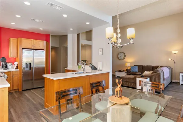 a very nice looking dining room with a large dining table and a chandelier