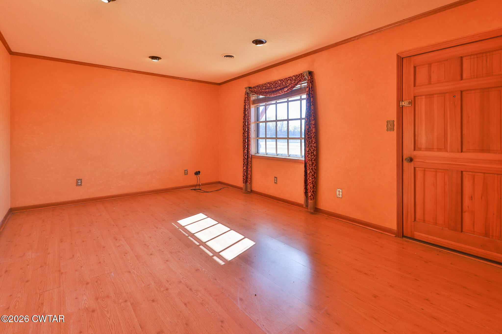 295 Adams Road Greenfield, TN 38230 - Photo 7 of 35 an empty room with wooden floor and windows