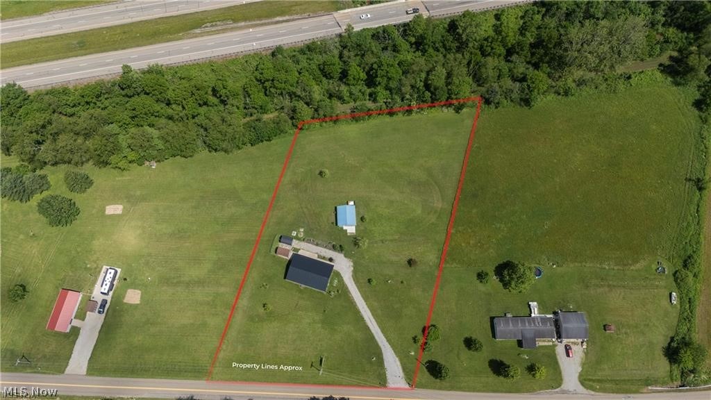 9427 Stonecreek Road Southwest Newcomerstown, OH 43832 - Photo 16 of 26 Expansive property featuring a grassy lot, mature trees, and direct road frontage