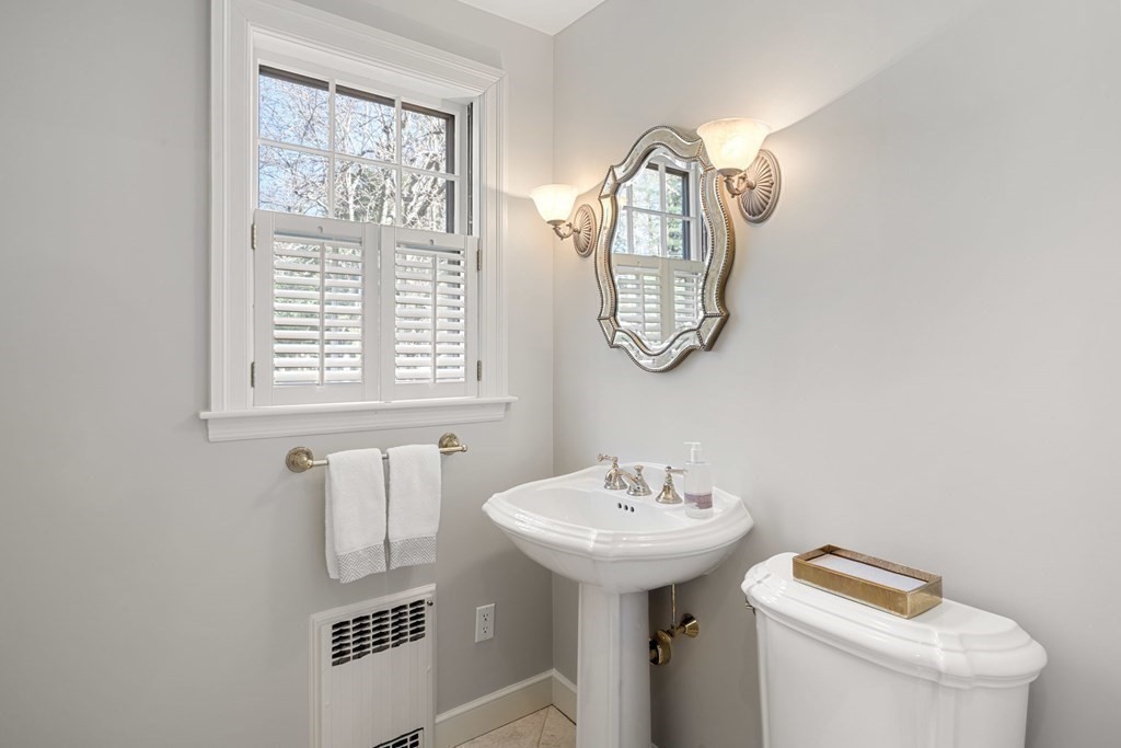 31 Lathrop Road Wellesley, MA 02482 - Photo 18 of 27 a bathroom with a toilet sink and mirror