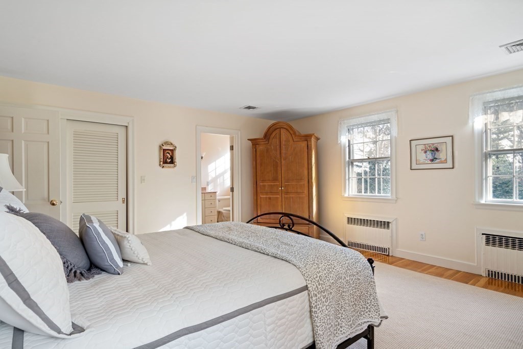 31 Lathrop Road Wellesley, MA 02482 - Photo 21 of 27 a bedroom with a bed and wooden floor