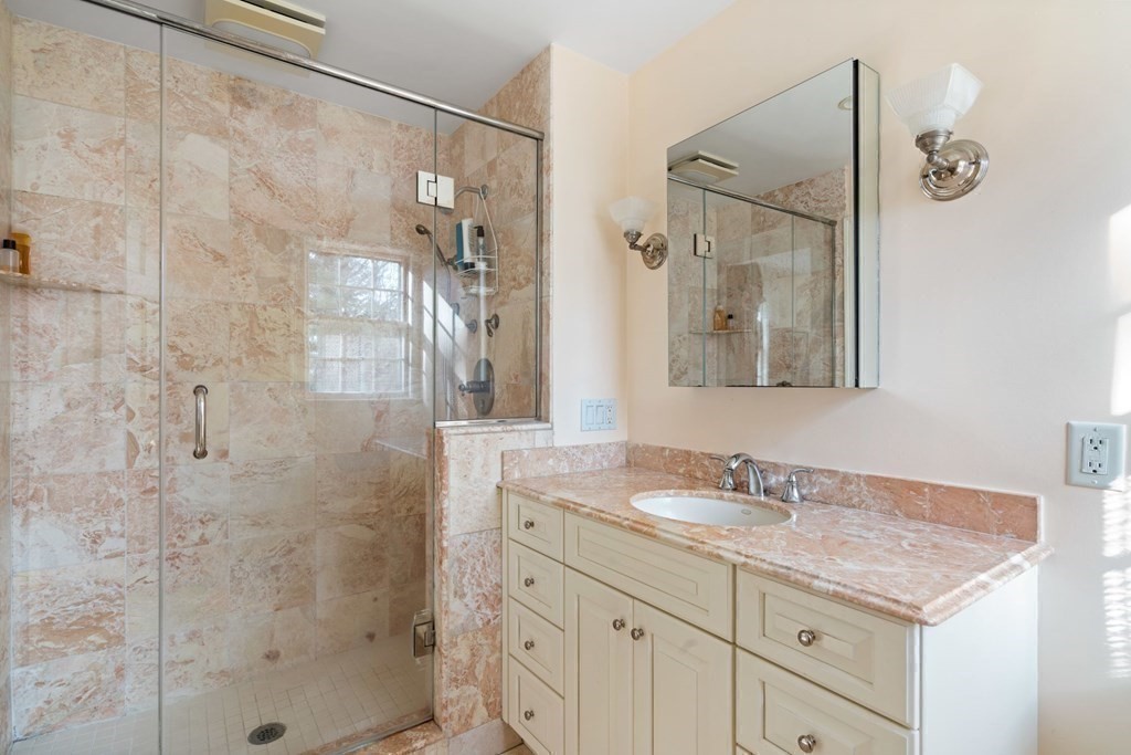 31 Lathrop Road Wellesley, MA 02482 - Photo 22 of 27 a bathroom with a granite countertop sink a mirror and shower