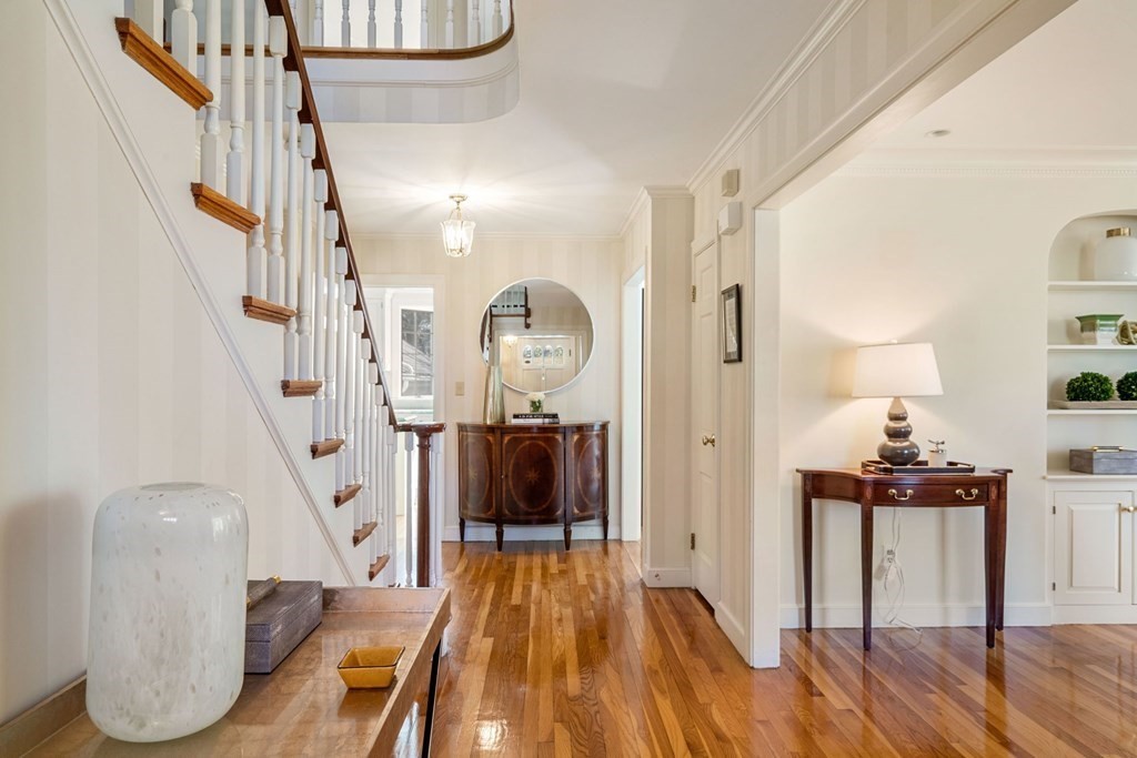 31 Lathrop Road Wellesley, MA 02482 - Photo 4 of 27 a view of a hallway with wooden floor staircase and a living room