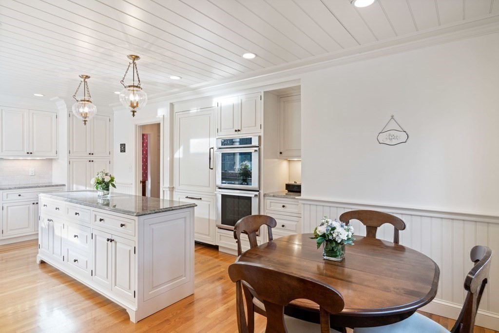 31 Lathrop Road Wellesley, MA 02482 - Photo 8 of 27 a kitchen with granite countertop a white stove top oven a sink a dining table and chairs