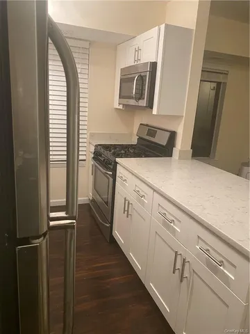 a kitchen with a refrigerator stove and sink
