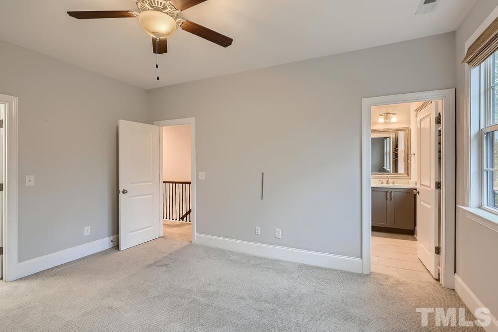 1604 Bowery Drive Raleigh, NC 27607 - Photo 13 of 28 an empty room with chandelier fan and windows