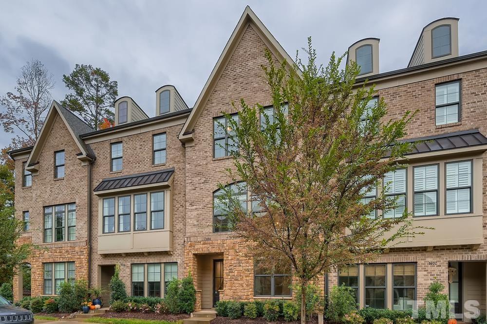1604 Bowery Drive Raleigh, NC 27607 - Photo 3 of 28 a view of a brick house with large windows and a flower plants