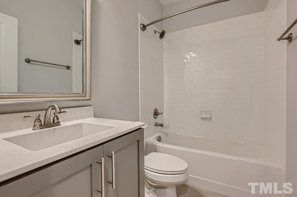 1604 Bowery Drive Raleigh, NC 27607 - Photo 21 of 28 a bathroom with a sink a toilet and shower