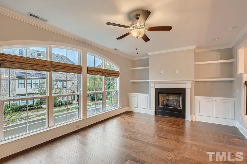 1604 Bowery Drive Raleigh, NC 27607 - Photo 5 of 28 a view of an empty room with a fireplace and a window