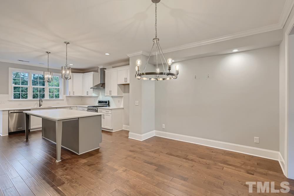 1604 Bowery Drive Raleigh, NC 27607 - Photo 8 of 28 a large kitchen with cabinets wooden floor and stainless steel appliances