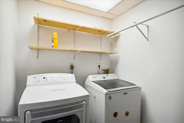 a view of a room with wooden floor and a window
