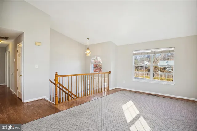 a bathroom with a granite countertop sink a toilet and a mirror