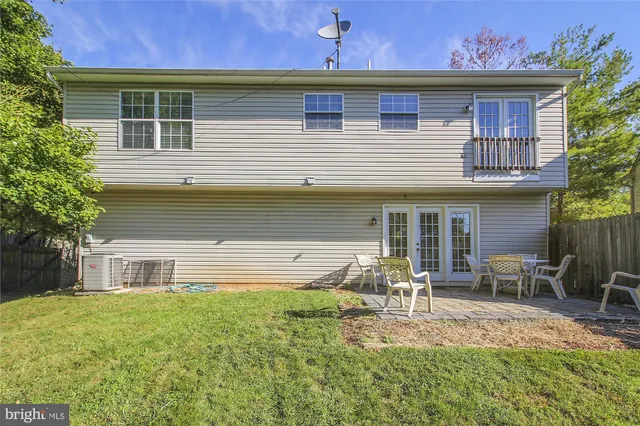 a view of a house with a small yard and wooden fence