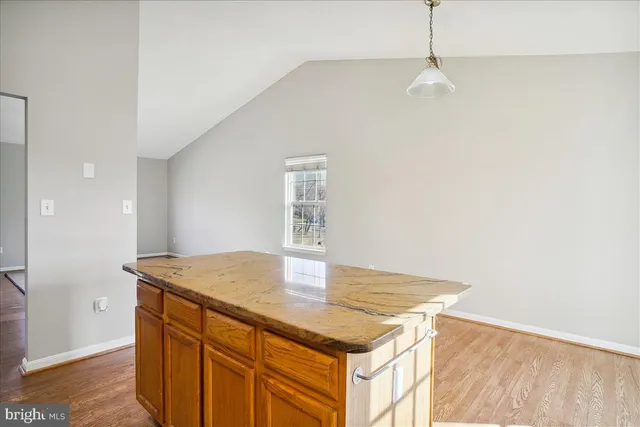 a kitchen with a sink cabinets and wooden floor