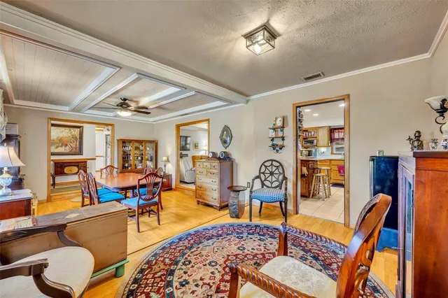 a living room with furniture kitchen view and a window