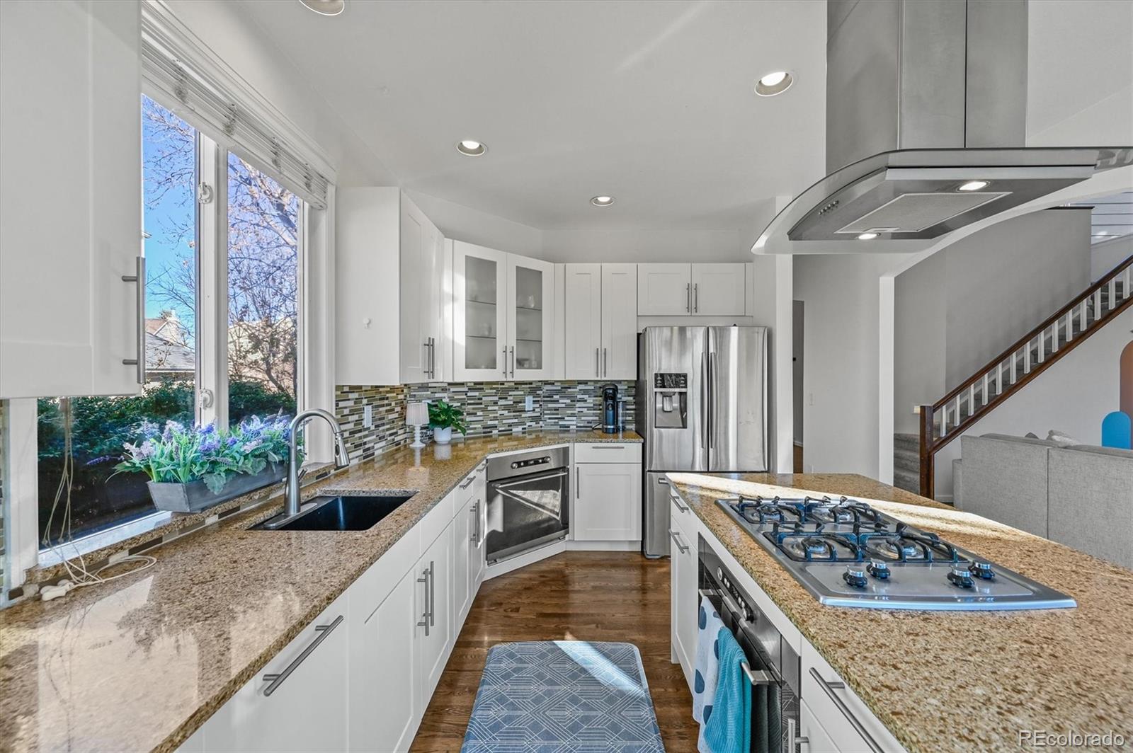 2249 Weatherstone Circle Highlands Ranch, CO 80126 - Photo 12 of 46 a kitchen with kitchen island granite countertop a sink stove and refrigerator