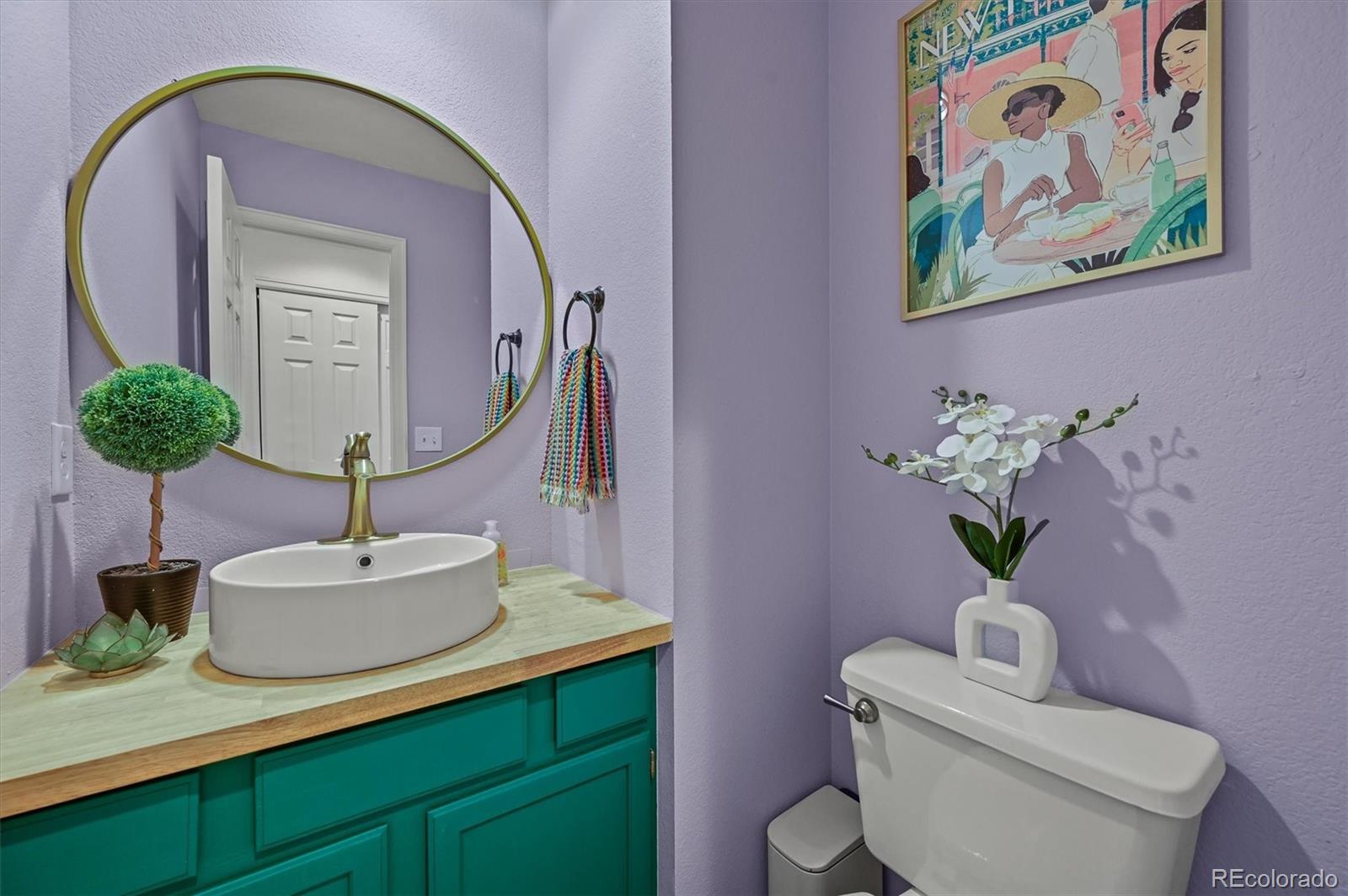 2249 Weatherstone Circle Highlands Ranch, CO 80126 - Photo 14 of 46 a bathroom with a toilet sink and mirror