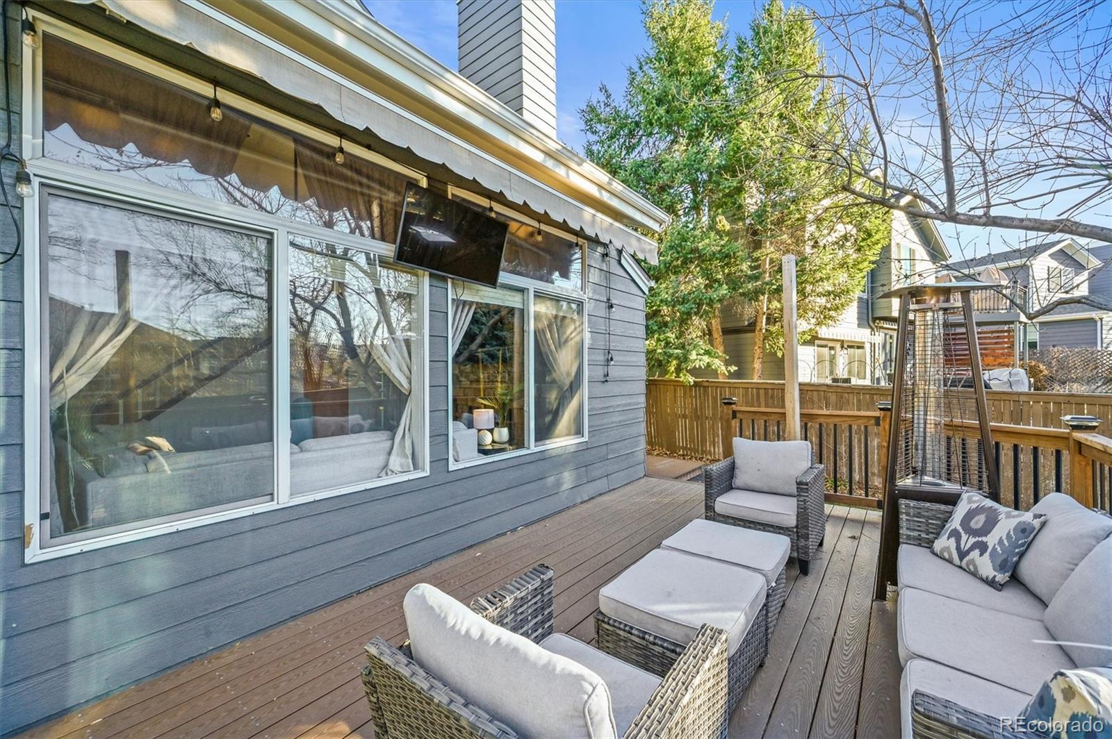 2249 Weatherstone Circle Highlands Ranch, CO 80126 - Photo 17 of 46 a view of a patio with couches chairs and wooden floor