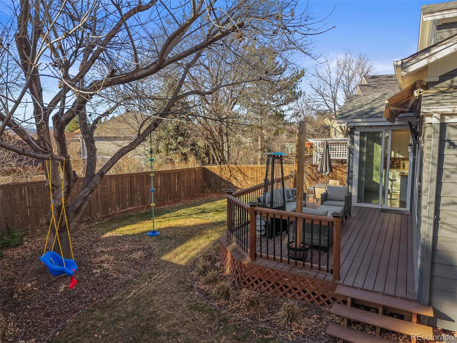 2249 Weatherstone Circle Highlands Ranch, CO 80126 - Photo 20 of 46 a view of a house with backyard and wooden floor