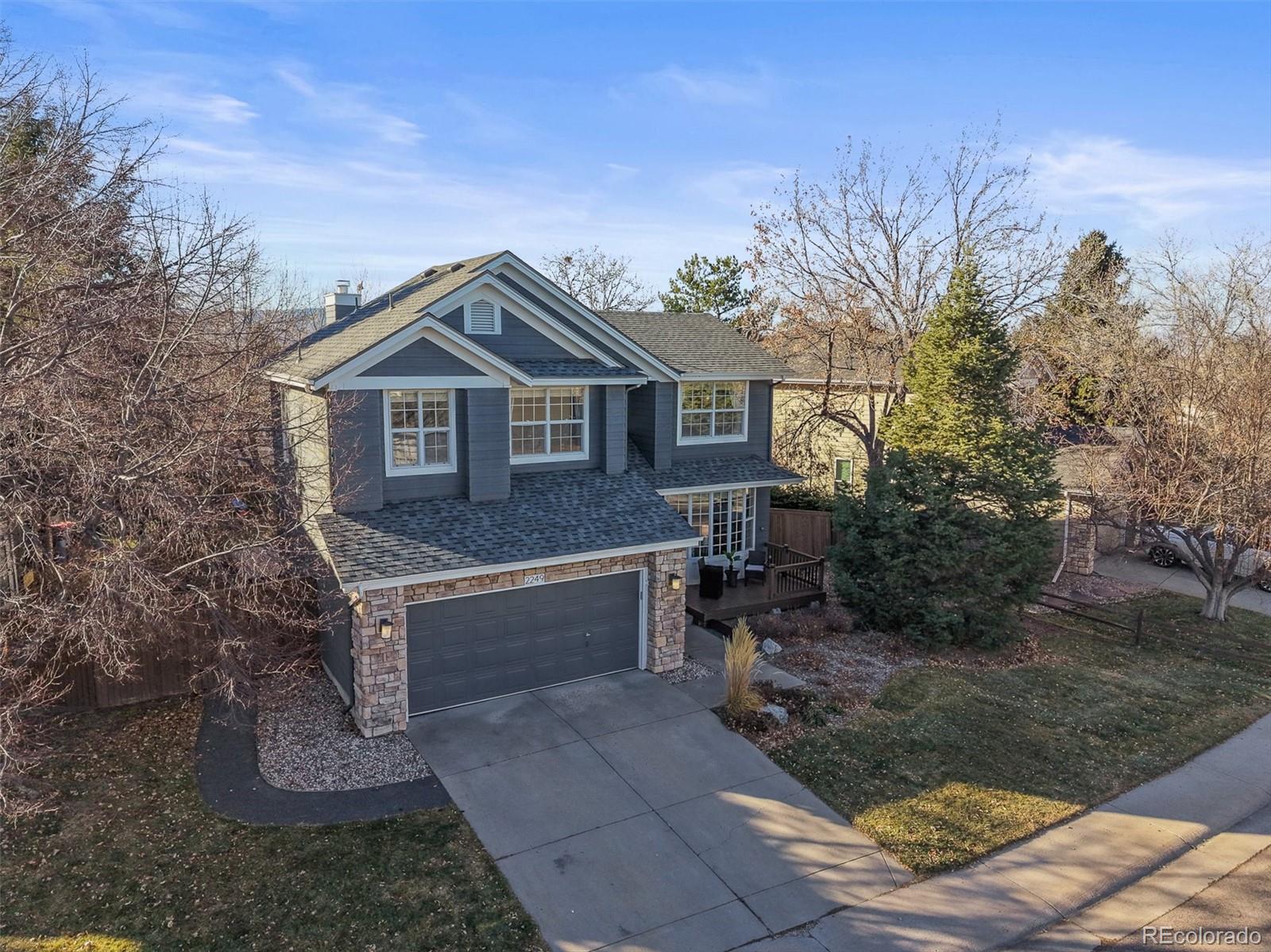 2249 Weatherstone Circle Highlands Ranch, CO 80126 - Photo 2 of 46 a front view of a house with a garden and yard