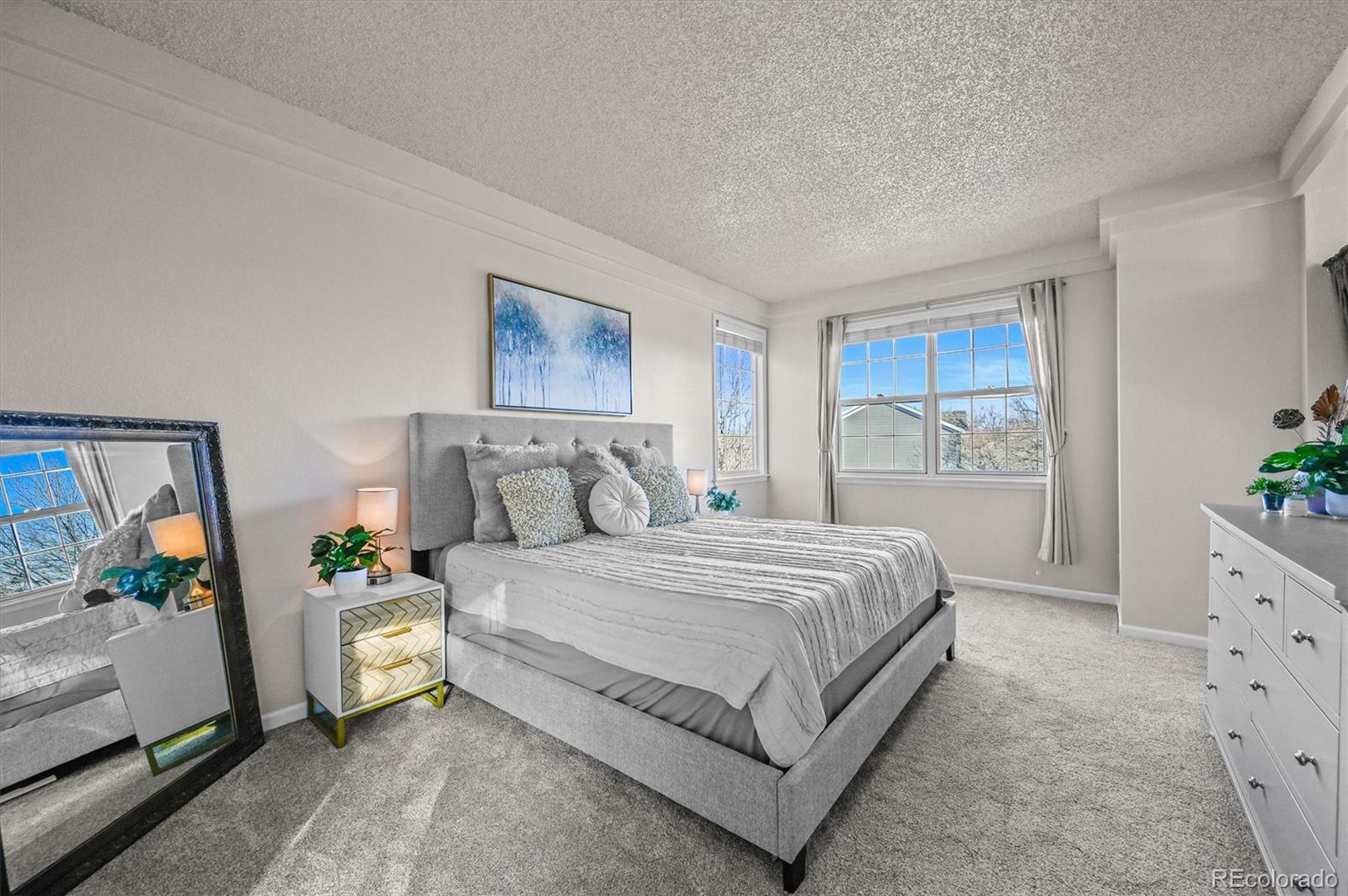 2249 Weatherstone Circle Highlands Ranch, CO 80126 - Photo 25 of 46 a bedroom with a large bed and a dresser