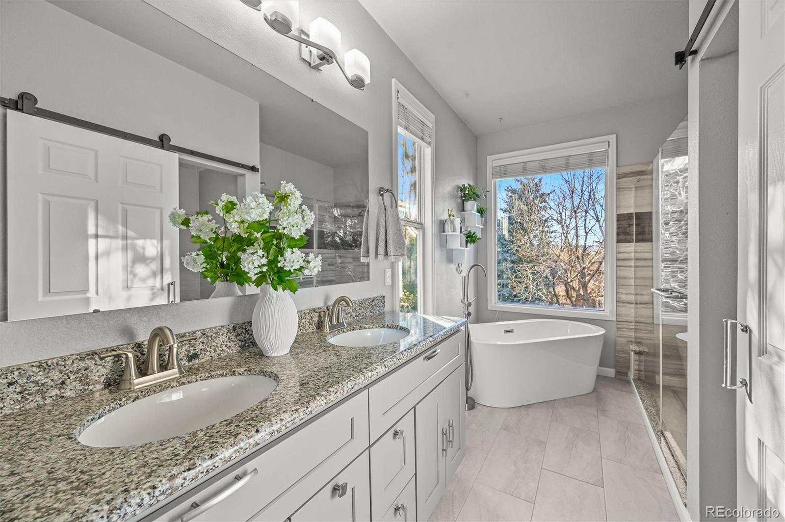 2249 Weatherstone Circle Highlands Ranch, CO 80126 - Photo 27 of 46 a bathroom with a granite countertop sink and a mirror
