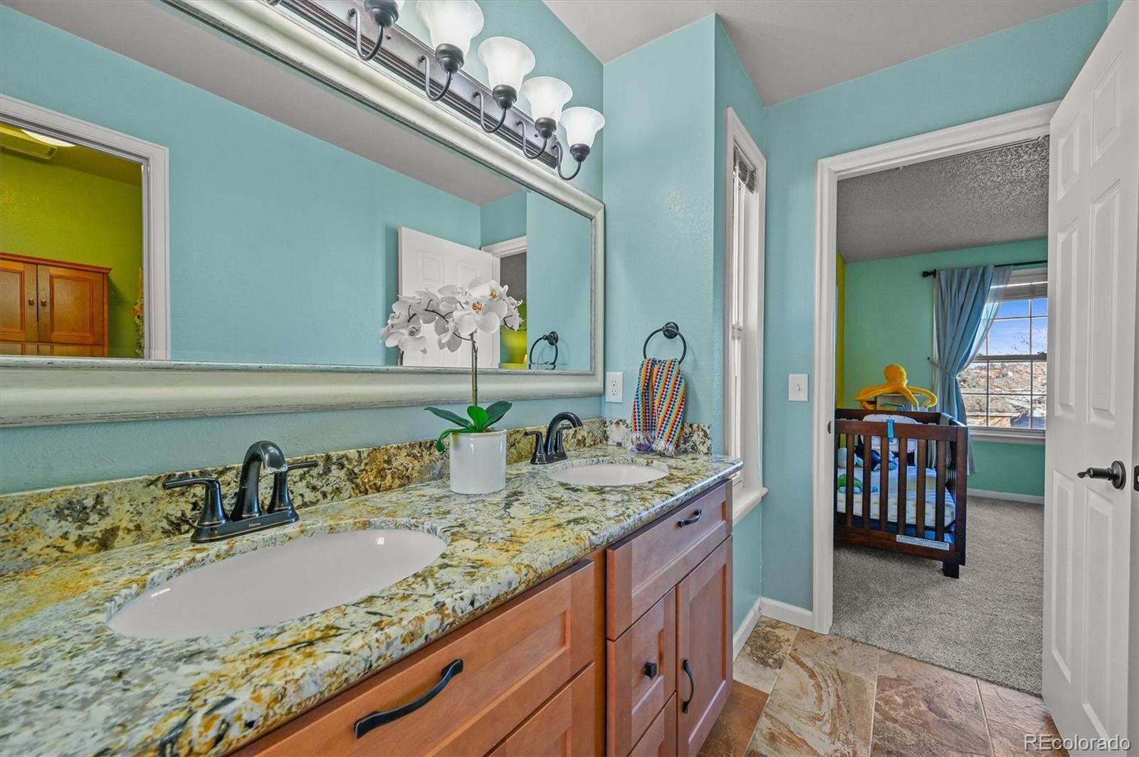 2249 Weatherstone Circle Highlands Ranch, CO 80126 - Photo 31 of 46 a bathroom with a granite countertop sink and a mirror
