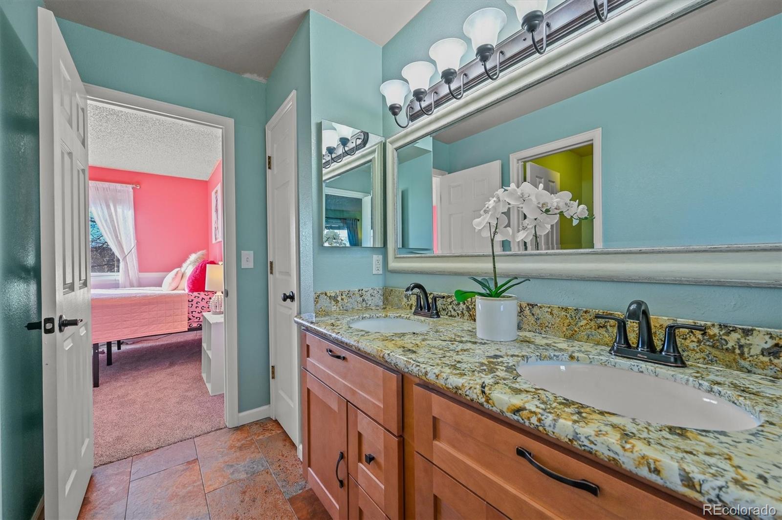 2249 Weatherstone Circle Highlands Ranch, CO 80126 - Photo 32 of 46 a bathroom with a granite countertop sink a toilet and a mirror