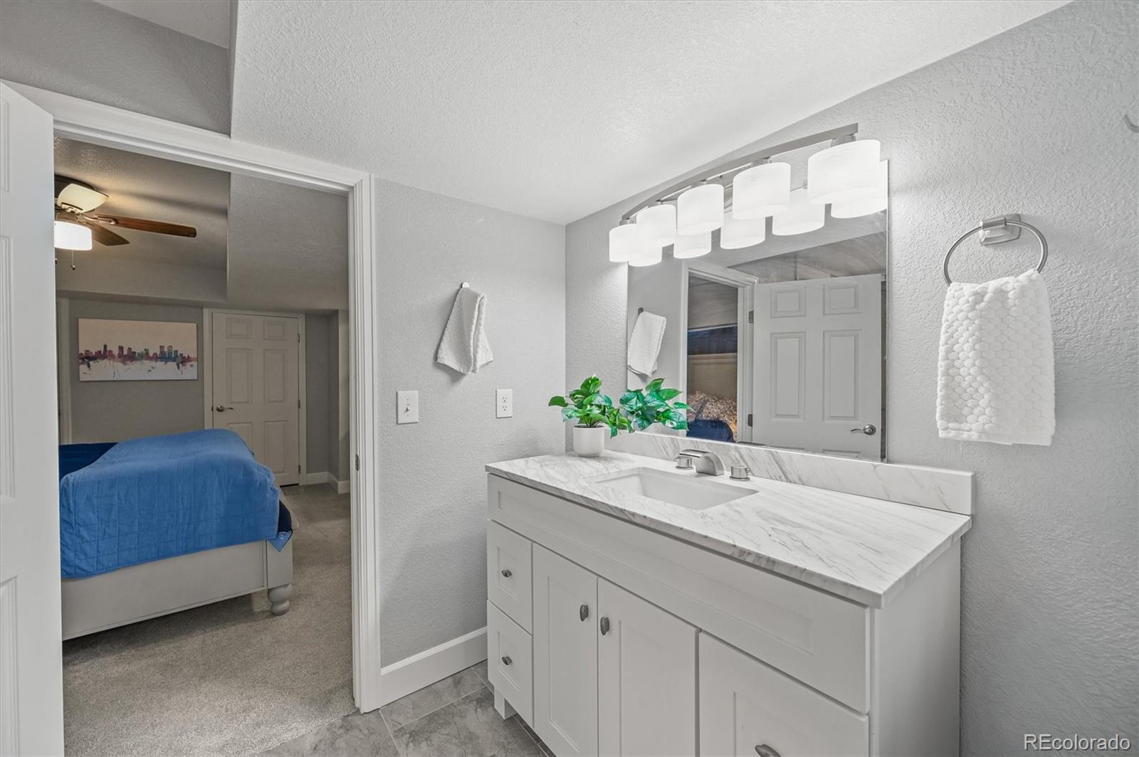 2249 Weatherstone Circle Highlands Ranch, CO 80126 - Photo 40 of 46 a bathroom with a granite countertop sink and a mirror
