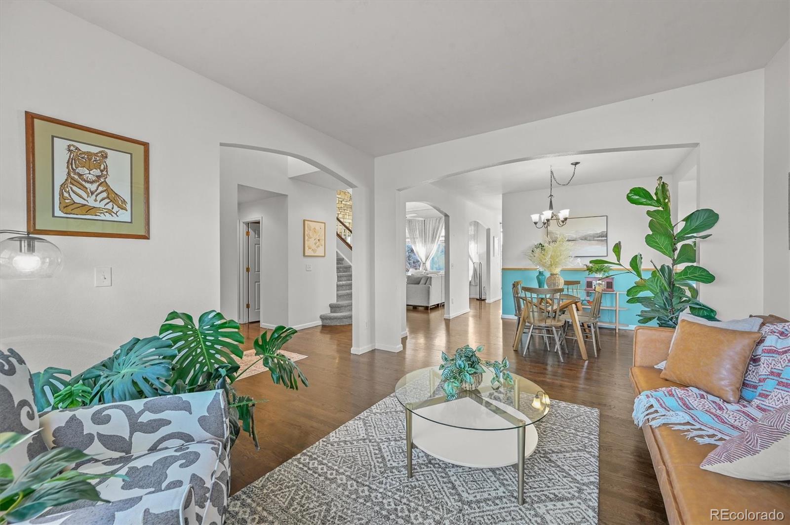 2249 Weatherstone Circle Highlands Ranch, CO 80126 - Photo 4 of 46 a living room with furniture and a potted plant