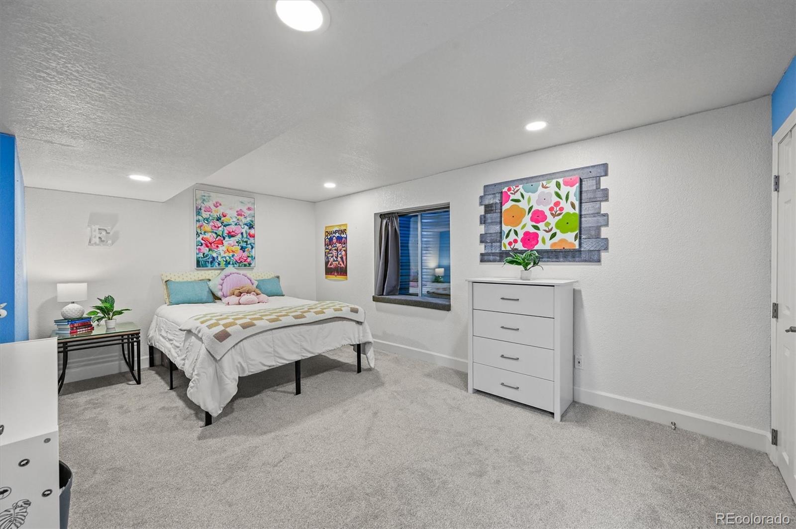 2249 Weatherstone Circle Highlands Ranch, CO 80126 - Photo 41 of 46 a spacious bedroom with a bed and a flat screen tv