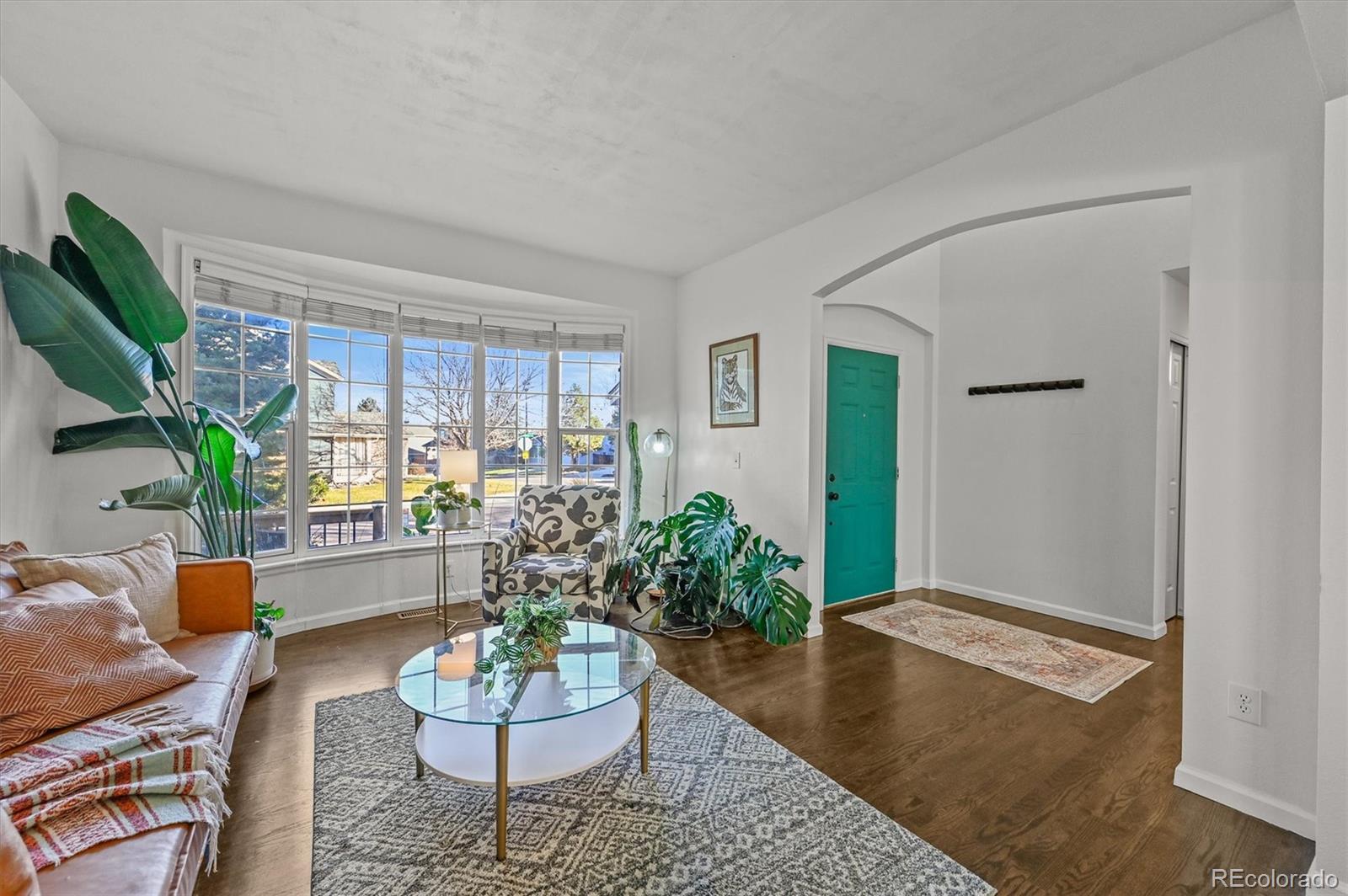 2249 Weatherstone Circle Highlands Ranch, CO 80126 - Photo 6 of 46 a living room with furniture potted plant and a window