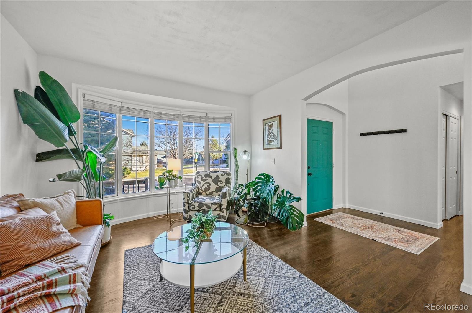 2249 Weatherstone Circle Highlands Ranch, CO 80126 - Photo 7 of 46 a living room with furniture potted plant and a window