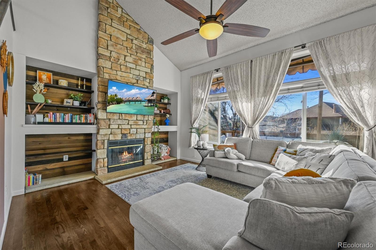 2249 Weatherstone Circle Highlands Ranch, CO 80126 - Photo 9 of 46 a living room with furniture and a fireplace