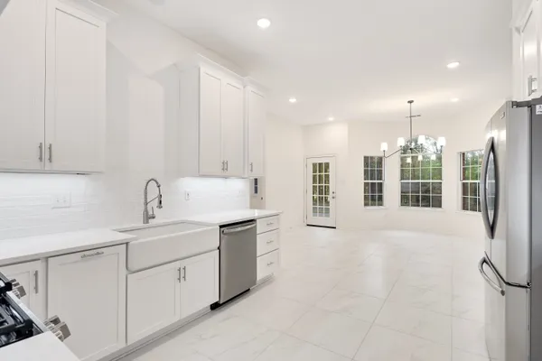 a view of staircase with white walls and wooden floor