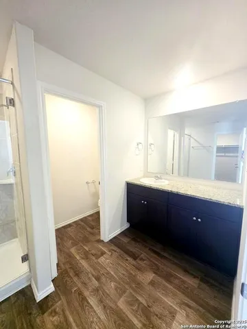 a bathroom with a glass shower door