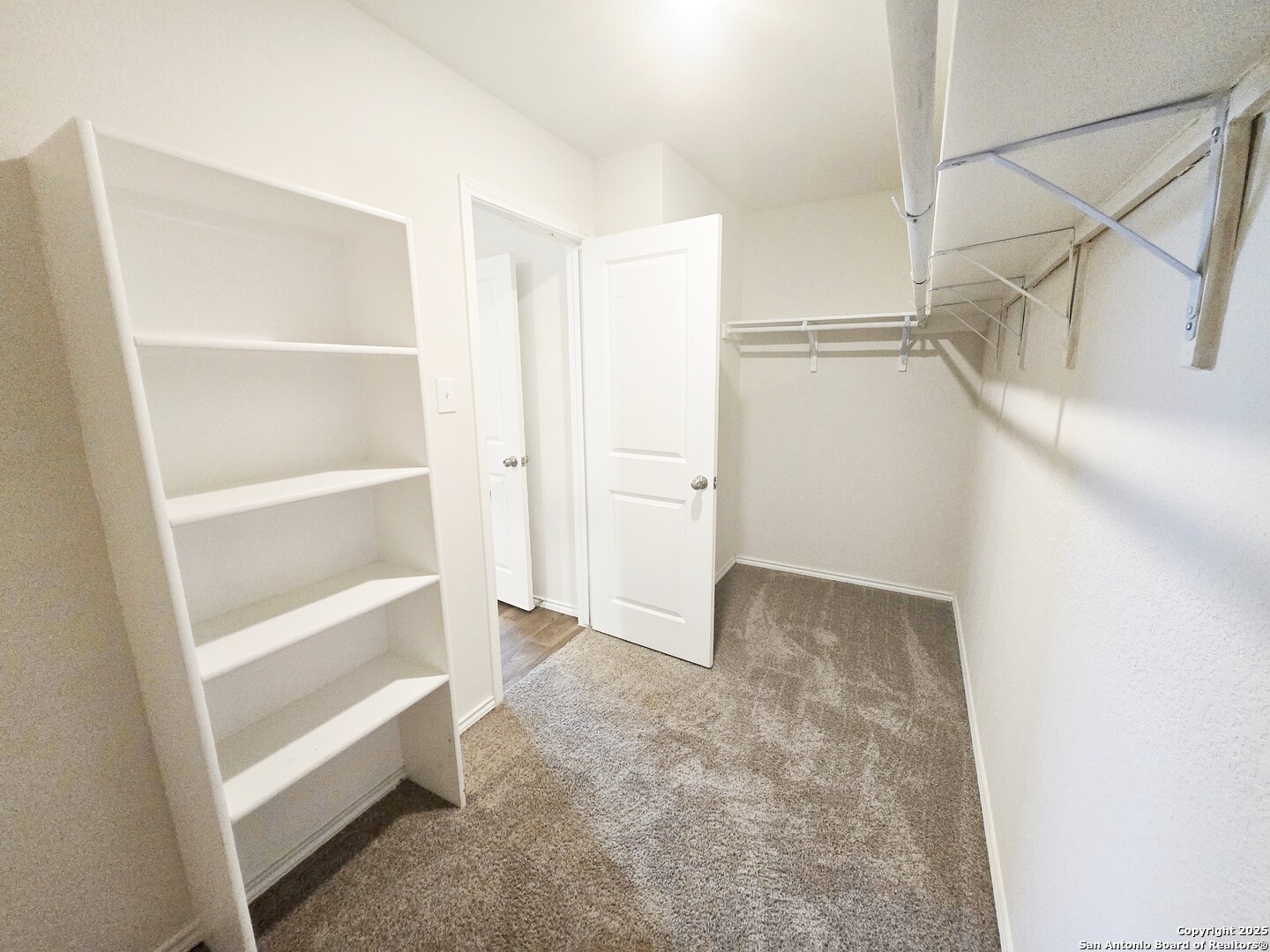 437 Middle Grn Loop Floresville, TX 78114 - Photo 15 of 25 a view of an empty walk in closet