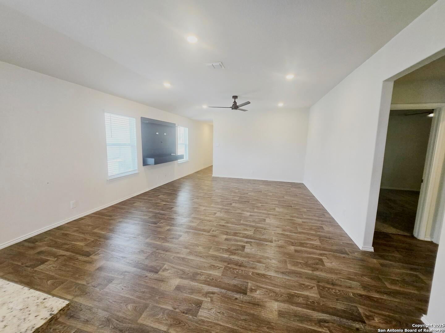 437 Middle Grn Loop Floresville, TX 78114 - Photo 5 of 25 an empty room with wooden floor and entrance