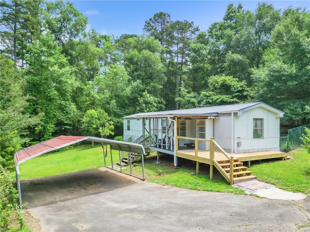 506 Charlies Creek Road Iva, SC 29655 - Photo 1 of 28 A welcoming front deck provides access to this charming single-story home nestled amongst lush greenery.