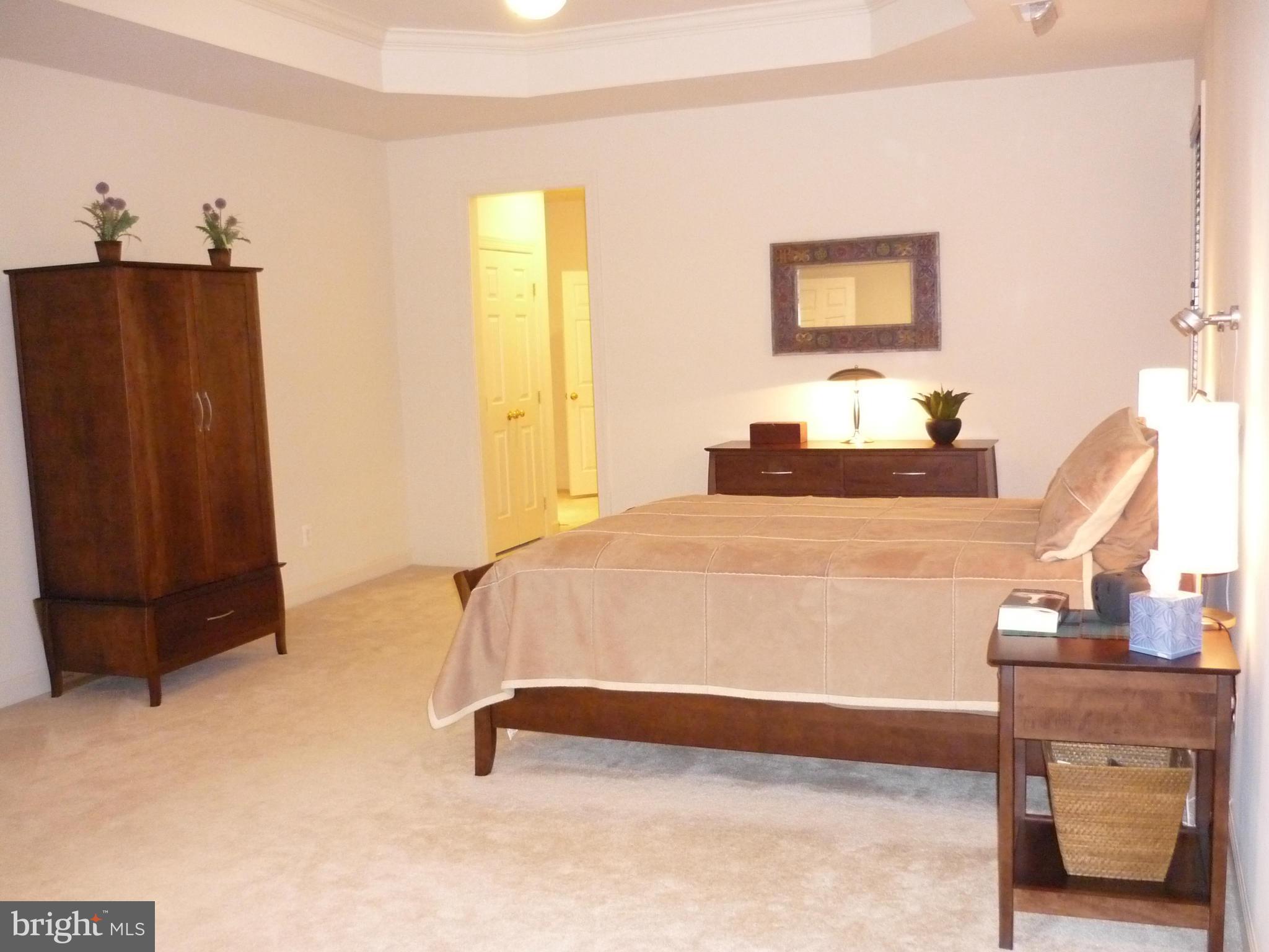 7258 Joshua Tree Circle Warrenton, VA 20187 - Photo 13 of 16 a bedroom with a bed and wooden floor