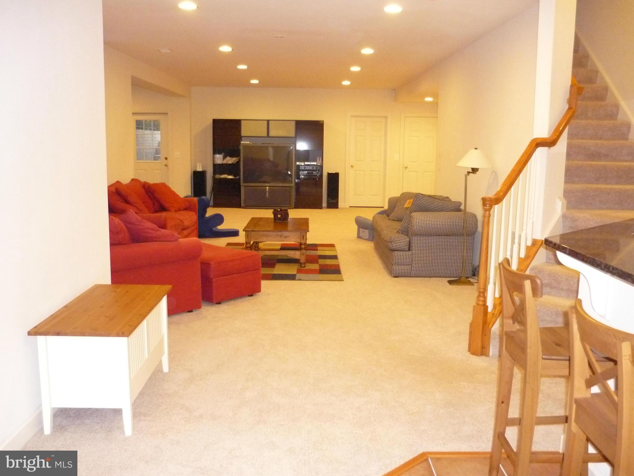 7258 Joshua Tree Circle Warrenton, VA 20187 - Photo 3 of 16 a living room with couches and kitchen view with wooden floor