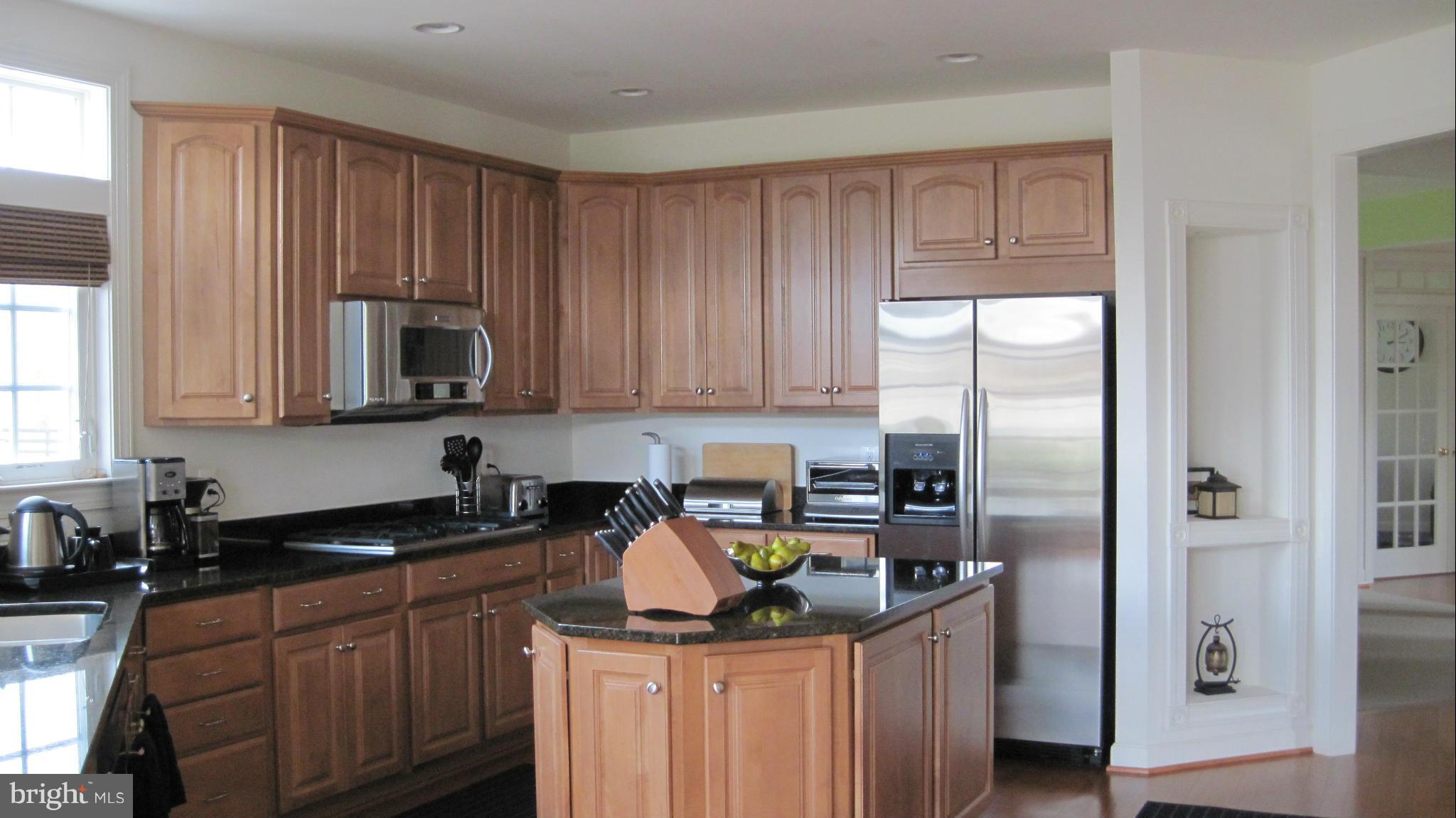 7258 Joshua Tree Circle Warrenton, VA 20187 - Photo 10 of 16 a kitchen with stainless steel appliances granite countertop a sink stove and refrigerator