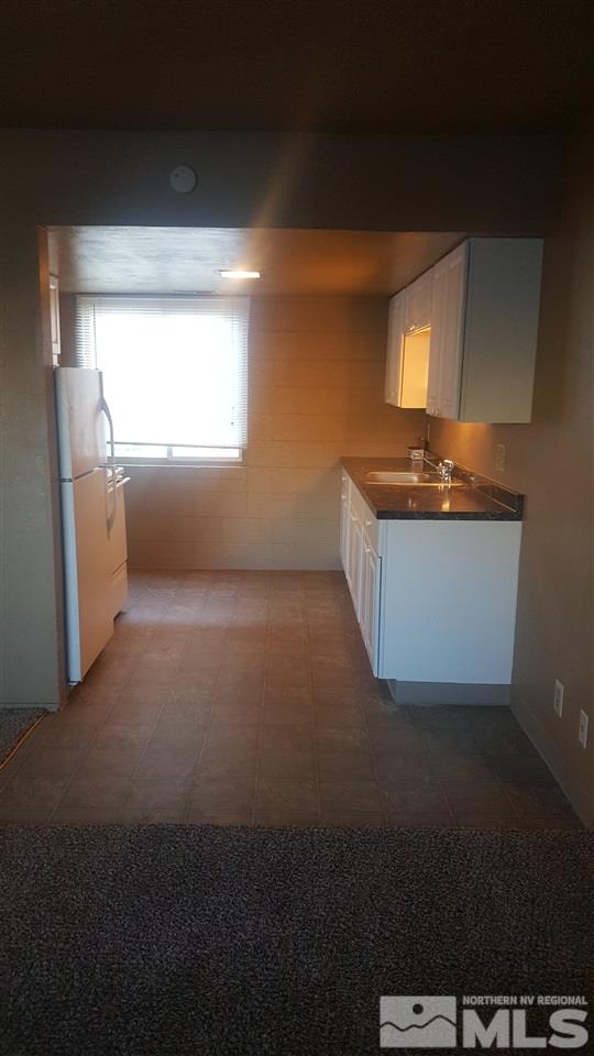 2430 Sutro Street, Unit 4 Reno, NV 89512 - Photo 2 of 6 a kitchen with a sink and a refrigerator