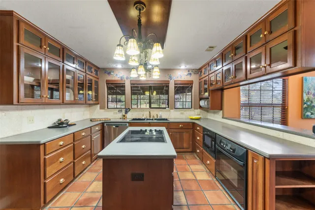 a kitchen with stainless steel appliances granite countertop a stove and a sink