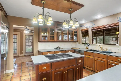 a kitchen that has a lot of cabinets in it