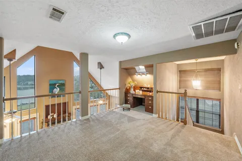 a view of a hallway with stairs