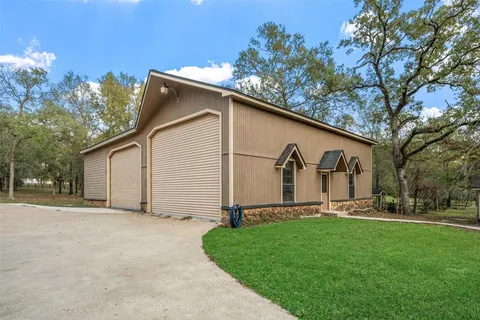 an aerial view of lake and residential houses with outdoor space
