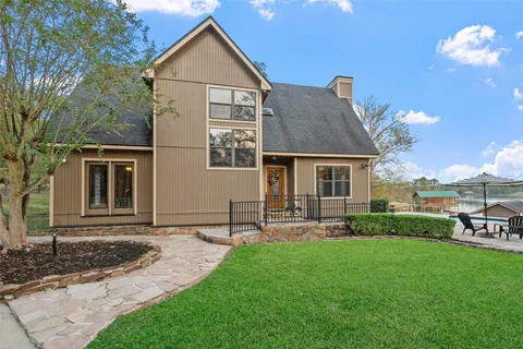 a front view of house with backyard and green space
